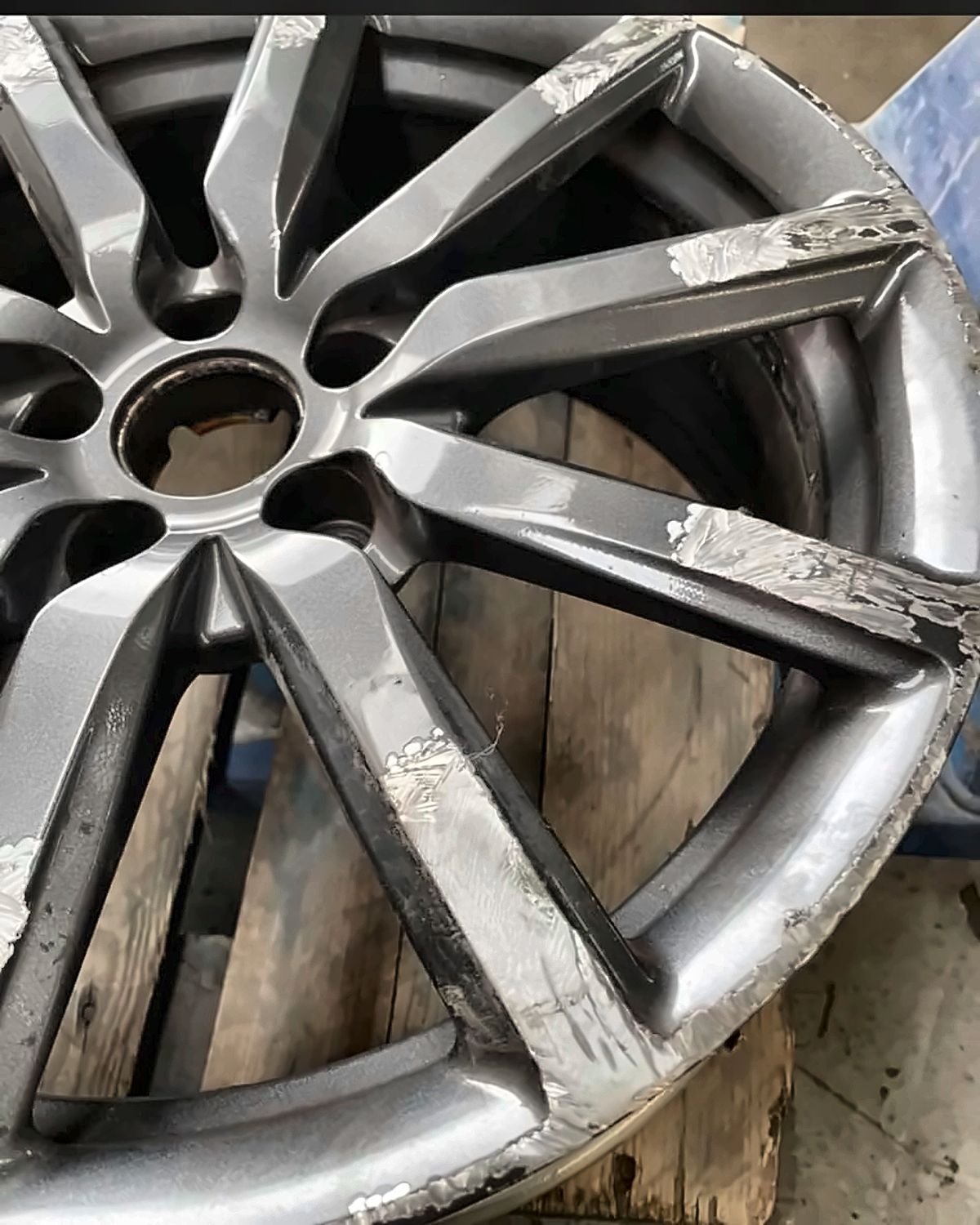 Vauxhall alloy wheel before - Kerb damage repaired, factory silver restored - Leatherhead